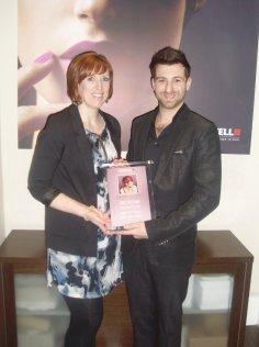 Paul Francis is presented her diploma by Rachel Hurley of Goldwell